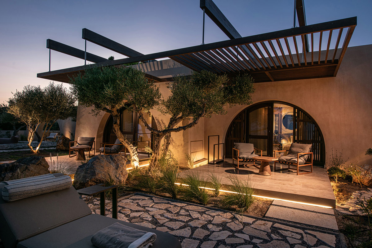 Evening view of the villa with pergolas and olive trees