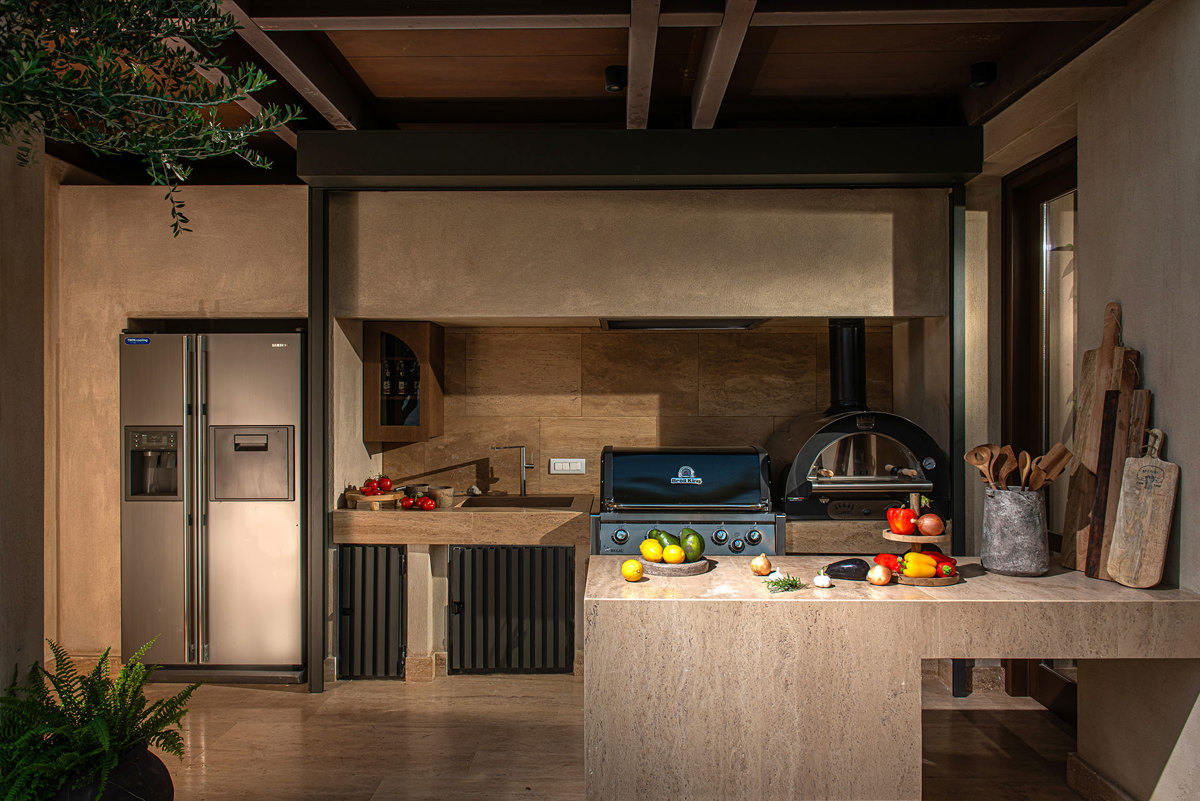 Outdoor kitchen with gas grill and pizza oven