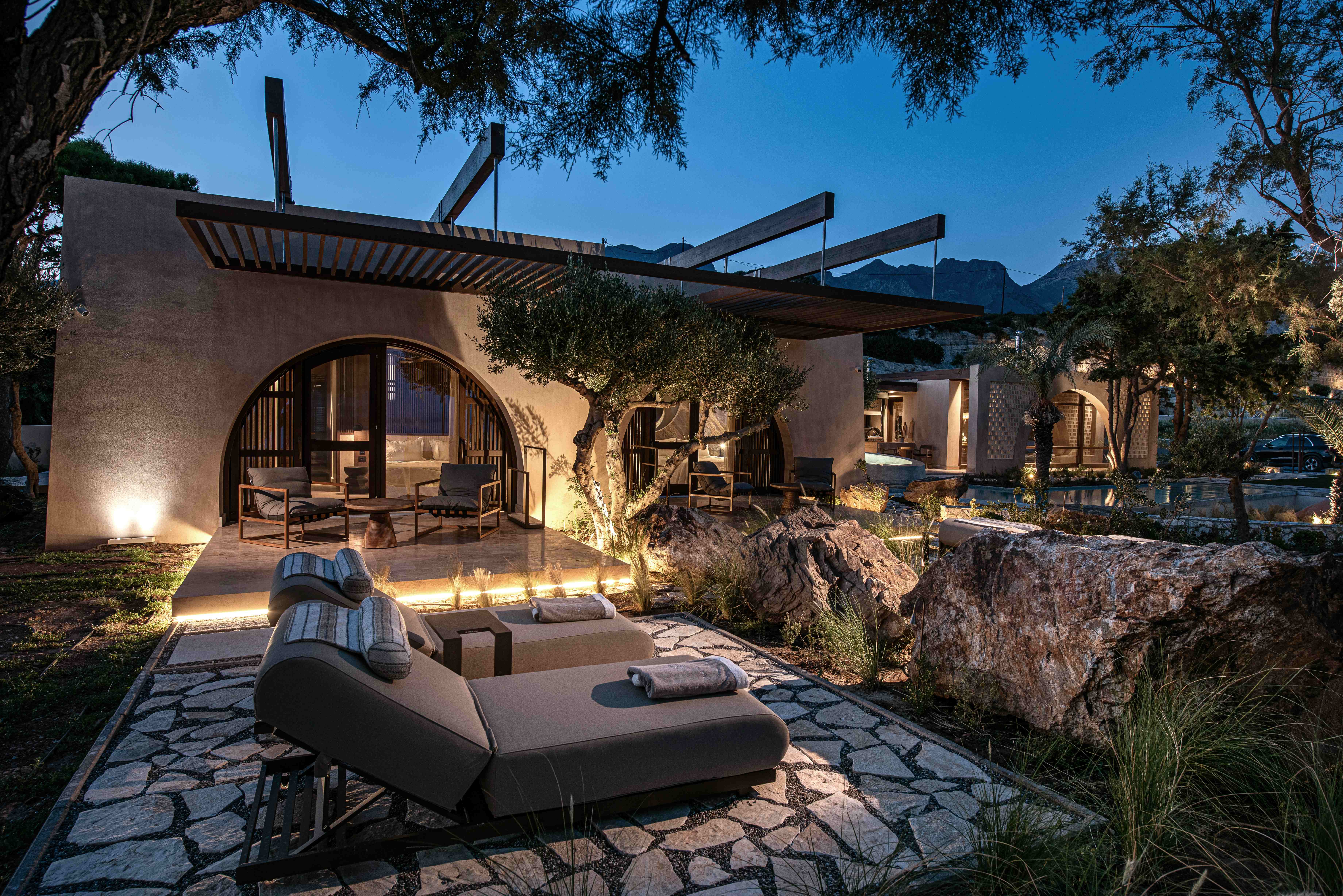 Villa exterior at twilight with lounge furniture and ocean view